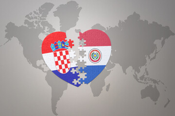 puzzle heart with the national flag of croatia and paraguay on a world map background.Concept.