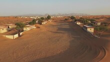 Desert Buried Village With Sand At UAE. Land Of Lost. On A Strip Of Desert Behind The Town Of Al Madam Lies A Tiny Ghost Village Lost In Sand. (aerial Photography)
