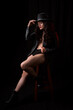 © Alfredo Hernández - Beautiful latin woman in black lingerie with a black jacket and a hat, low key photography with spot light.