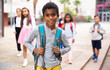 © JackF - Portrait of african american boy standing near school, children on background
