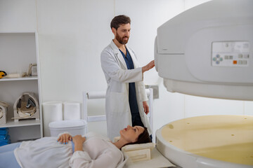 Wall Mural - Radiologist controls MRI or CT or PET Scan with female patient undergoing procedure