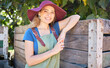 © Jade M/peopleimages.com - Portrait of a happy woman on a farm. Young farmer on a organic, sustainable orchard on a sunny day. Female smiling on peaceful farmland, leaning on a wooden crate after picking apples in nature