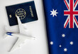 Flag of Australia with passport and toy airplane. Flight travel concept 