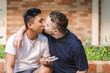 © Austockphoto - Gay men kissing