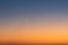 Sunset On Clear Sky With Moon And The Star.