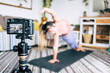 © simona - Fitness and home gym workout exercises production from content creator. Concept of healthy job and lifestyle work. People record on camera a pilates fitness lesson. Modern technology freelance work