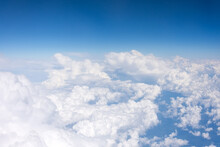 Aerial View From Above At High Altitude Of Dense Puffy Cumulus Clouds Flying In Day.