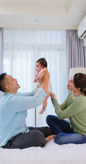 Canvas Print - Happy family playing with baby