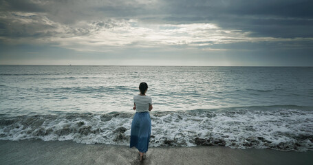 Wall Mural - woman walking at beach