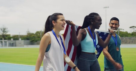 Wall Mural - American female athlete gold medalist with a US flag celebrating. Happy African athletics winner walking with competitors on sports ground. Successful sports woman with her sports friends on a track