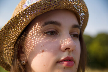 close up portrait of a beautiful sexy  woman  in straw hat in backlight