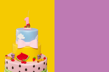 Wall Mural - fruit-themed cake decorated for a first-year children's party on yellow and purple background.