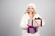 © rastockinc - Young woman in winter outfit offering gifts
