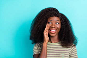 Sticker - Photo of adorable charming lady wear striped t-shirt looking empty space telling secret isolated turquoise color background