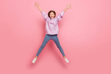 Poster - Photo of cute excited girl knitwear sweater jumping high like star isolated pink color background