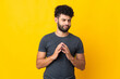 © luismolinero - Young Moroccan man isolated on yellow background scheming something
