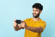 © luismolinero - Young Moroccan man isolated on blue background playing with the mobile phone