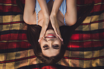 Top above high angle view portrait of attractive cheerful girl lying on cover fresh air spending time relax outdoors