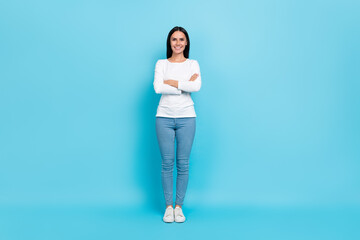 Wall Mural - Full length photo of young lovely woman standing crossed hands wear casual clothes isolated over blue color background