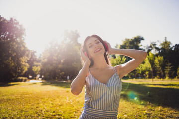 Poster - Portrait of attractive cheerful dreamy girl listening stereo sound enjoying breathing fresh air pastime outdoors