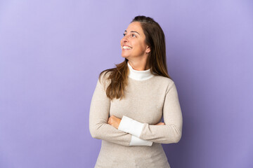 Middle age Brazilian woman isolated on purple background happy and smiling