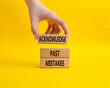 Acknowledge Past Mistakes symbol. Wooden blocks with words Acknowledge Past Mistakes. Beautiful yellow background. Businessman hand. Business and Acknowledge Past Mistakes. Copy space