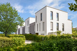Fototapeta Londyn - Modern townhouses in a residential area, new apartment buildings with green outdoor facilities in the city