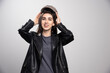 © rastockinc - Photo of a woman posing in black leather jacket and cap
