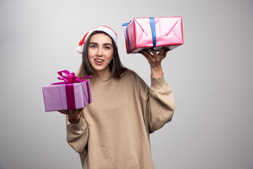 Young woman showing two boxes of Christmas presents