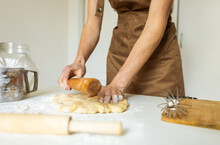 A Woman In A Special Apron Cooks At Home. Rolling Out And Preparing Dough For Baking.