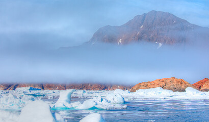 Wall Mural - fast moving motorboat trying to get out of the ice - stranded icebergs in the fog at the mouth of th