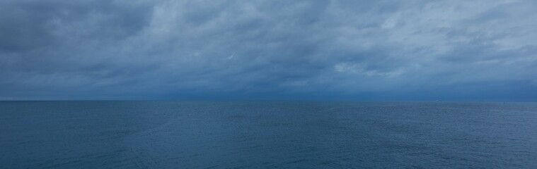 Wall Mural - Baltic sea at night. Dramatic sky, storm clouds. Dark atmospheric seascape. Panoramic view. Nature, weather, environment themes