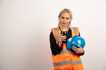 Woman worker posing with cup of coffee on white background