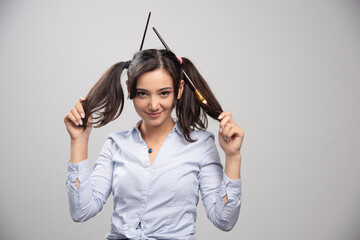 Wall Mural - Woman artist showing her hair with paintbrushes