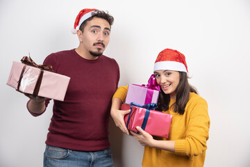 Wall Mural - Young man with woman posing with Christmas presents