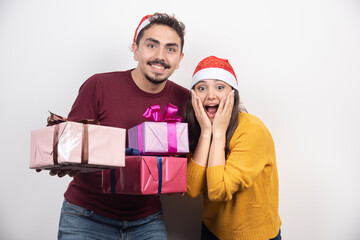 Wall Mural - Young man with woman posing with Christmas presents