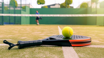 Wall Mural - One caucasian mature man playing behind net with padel racket and yellow ball