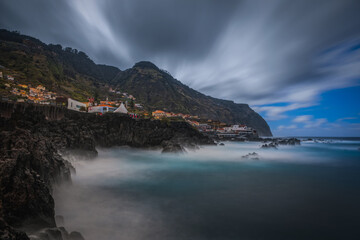 Wall Mural - Beautiful nature landscape with Atlantic Ocean and lava rock natural swimming pools in Porto Moniz, Madeira, Portugal. Long exposure picture, october 2021