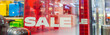 Discount percentage sign display in fashion department store during sale season period. Sale tag of offering special promotion hanging in shopping mall, web banner.