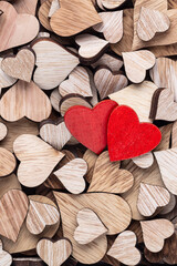 Wall Mural - Wooden hearts, one red heart on the heart background.