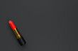 Red lipstick close-up on a black background with copy space. Women's cosmetics for professional makeup. Beauty concept. Top view. 3d rendering illustration