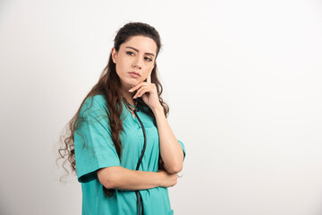 Wall Mural - Portrait of female healthcare worker posing on white background