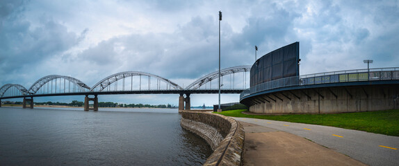 Wall Mural - Panoramic landscaper of Centennial Bridge over the Mississippi River and the curved bike trails and footpaths, the view from LeClaire Park and Bandshell in Davenport, Iowa