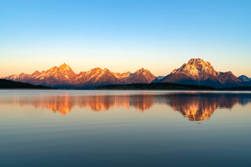 Poster - landscape of snow mountain under morning sunlight reflecting in the lake