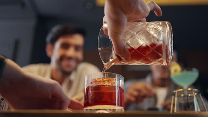 Poster - 4K Professional male bartender preparing and serving cocktail drink to customer on bar counter at luxury nightclub. Barman making mixed alcoholic drink for celebrating holiday party at restaurant bar.