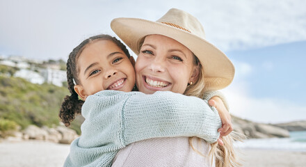 portrait of a little girl bonding and hugging her mother at the beach. carefree mom having fun with 