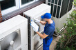 © Andrey Popov - An Electrician Men Checking Air Conditioning Unit