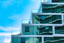 Detail Glass Window, Wall And Balcony Railing In Modern Building Architecture Over Blue Sky Background