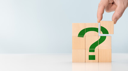Fototapete - Cubes with green question marks, closeup. Space for text. hand hold Questions Mark word with wooden cube block on table background. FAQ frequency asked questions, Answer, Information