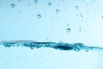 Poster - beautiful blue splash of water in a glass vessel